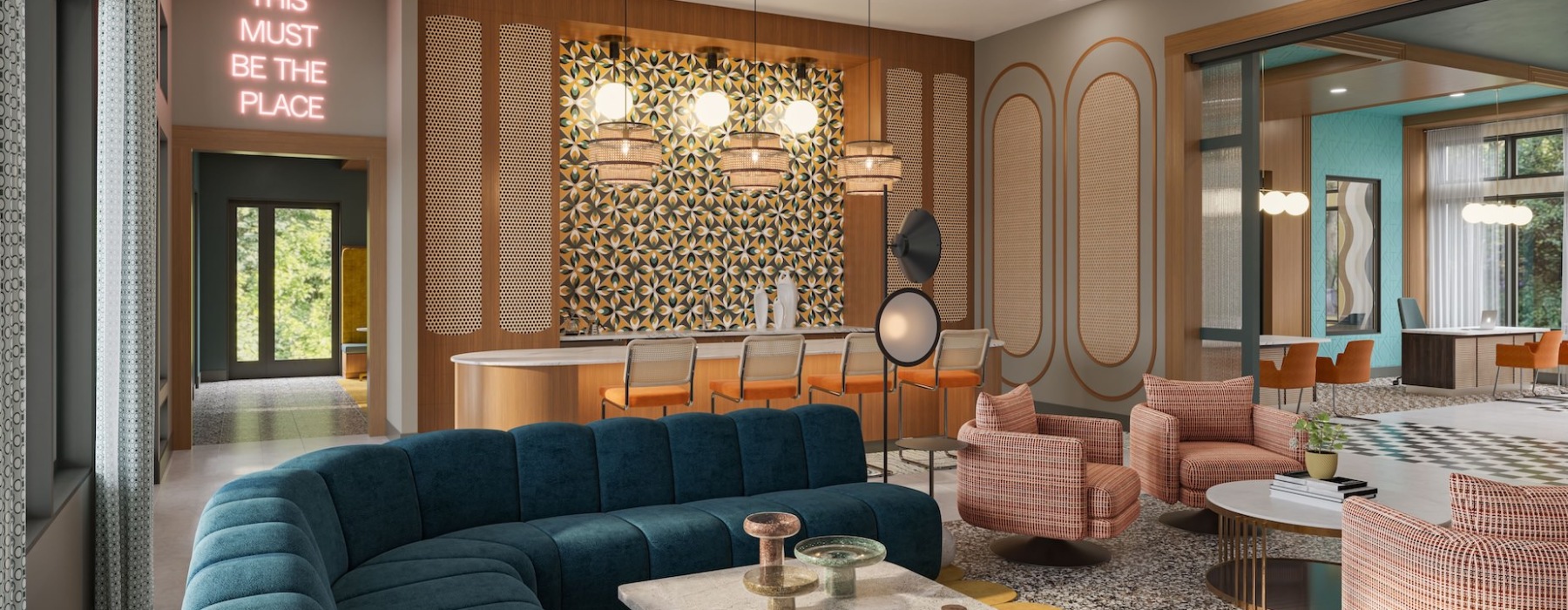 Modern clubroom with blue velvet couch and pink velvet chairs
